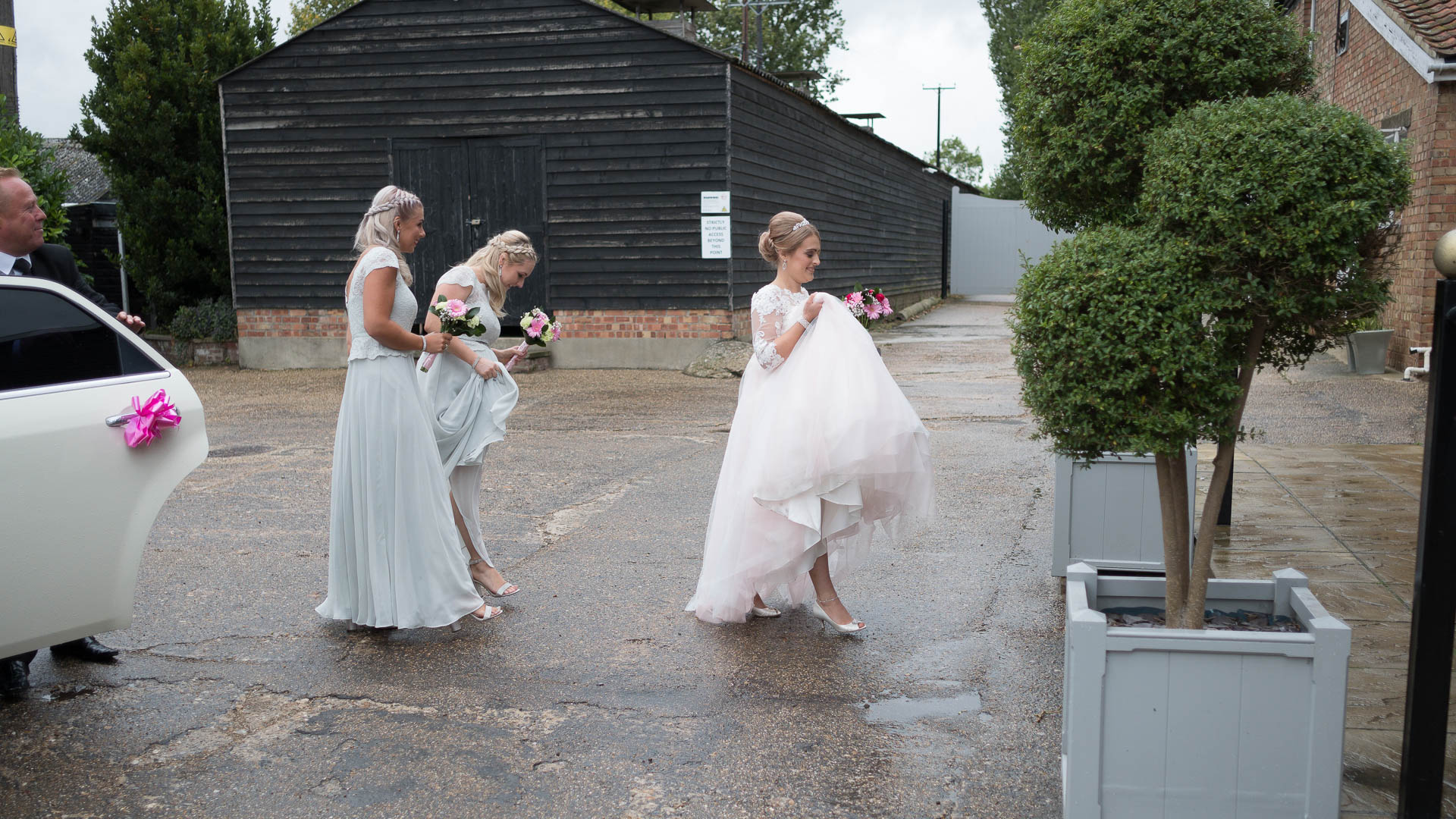 Bride running in the rain to go get married at All Manor of Events, Suffolk Wedding Photographer, Heffs Photography
