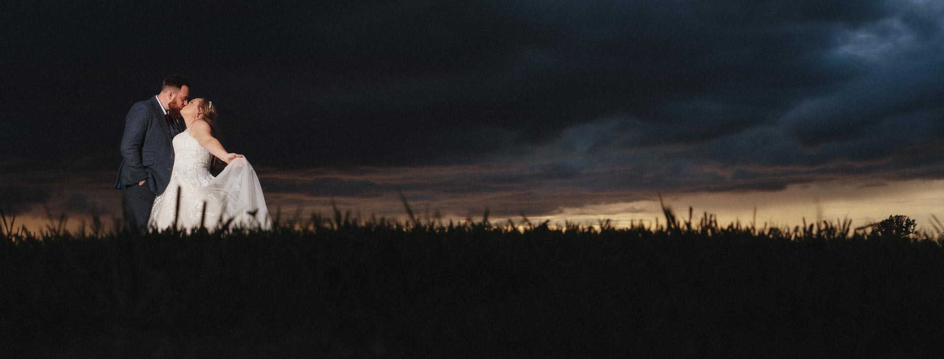 Wedding couple posing for a portrait against a moody sky, Suffolk Wedding Photographer, Heffs Photography, All Manor of Events, 