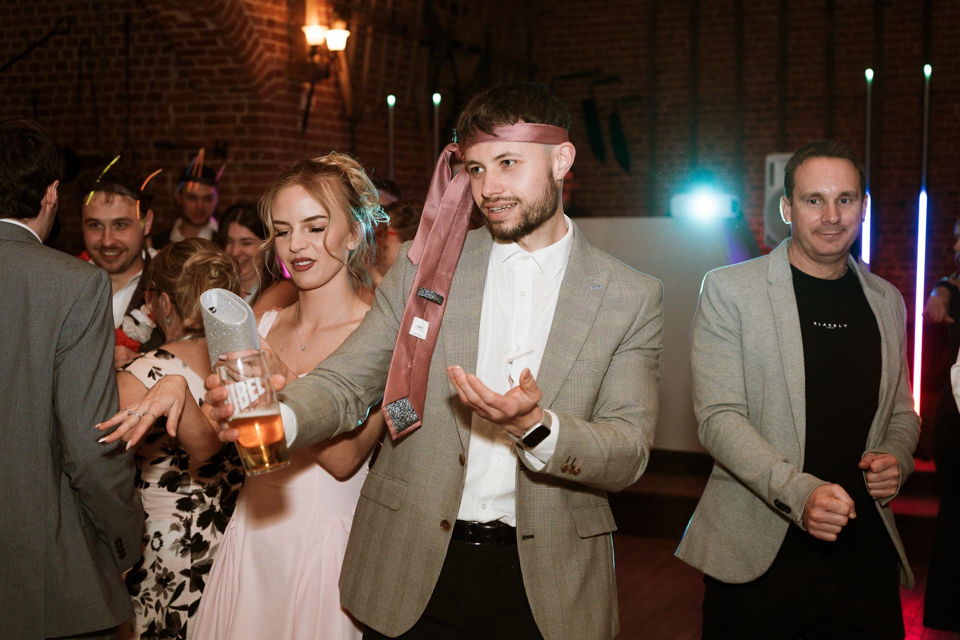 man dancing with a tie around his head, Norfolk Weddings, Heffs Photography, 
