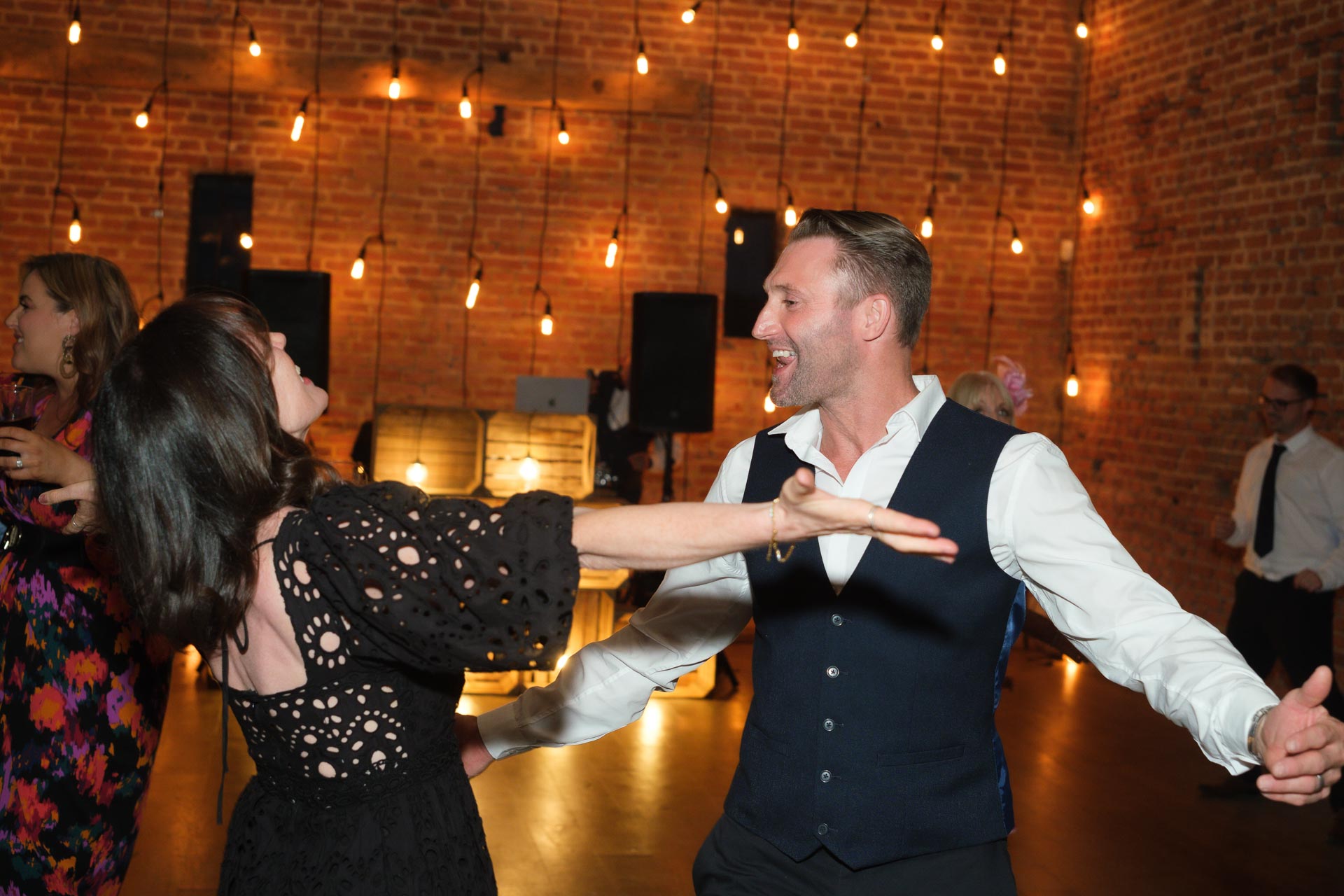 couple dancing against a backlit dancefloor, Suffolk Wedding, Copdock Hall,