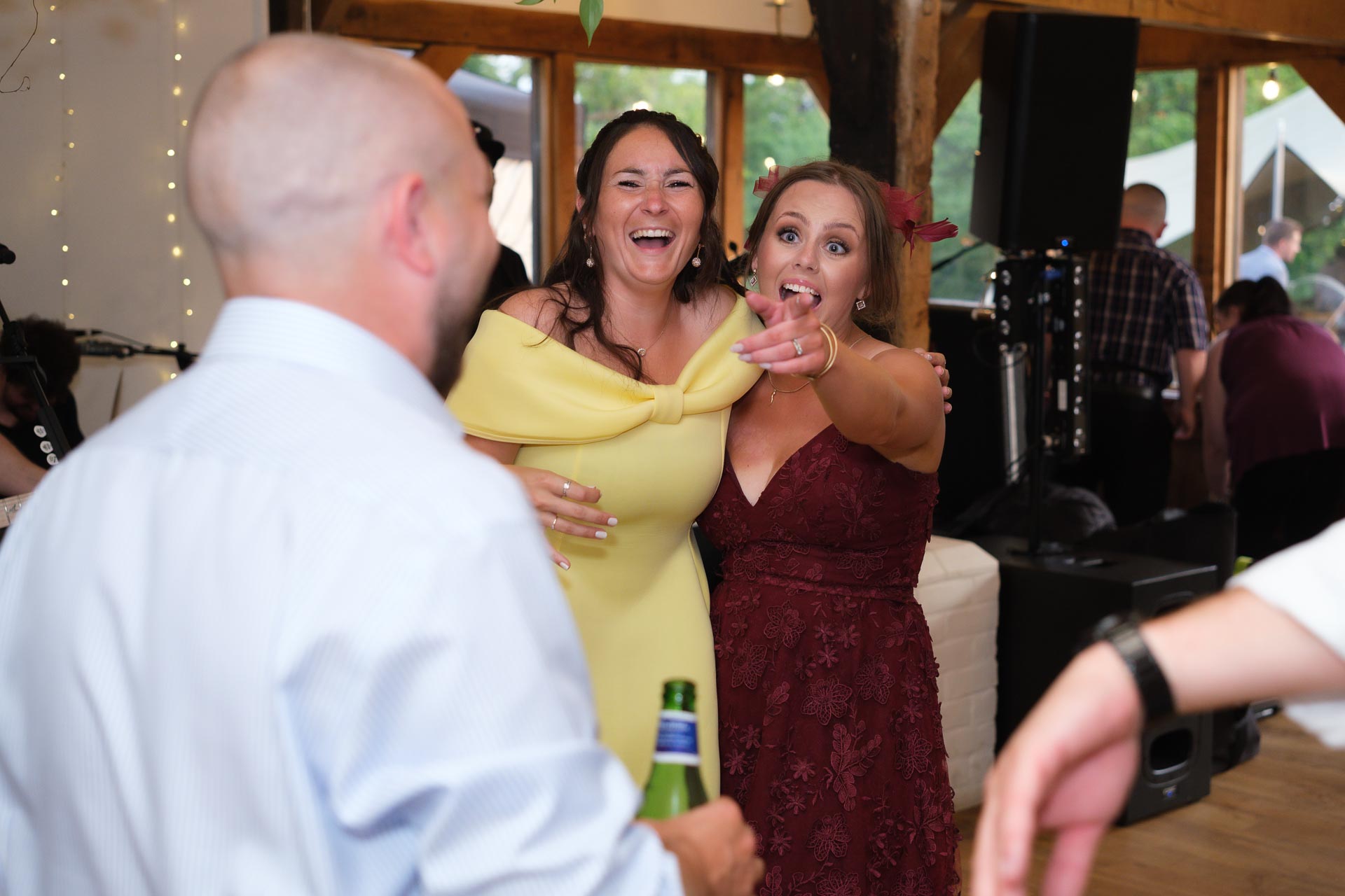 Ladies pointing at the camera on the dancefloor, Heffs Photography, Suffolk Weddings, 